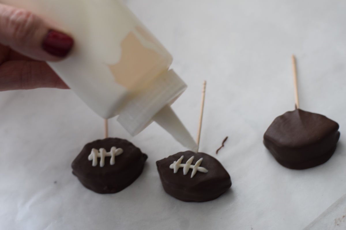 adding chocolate laces to football Oreo 