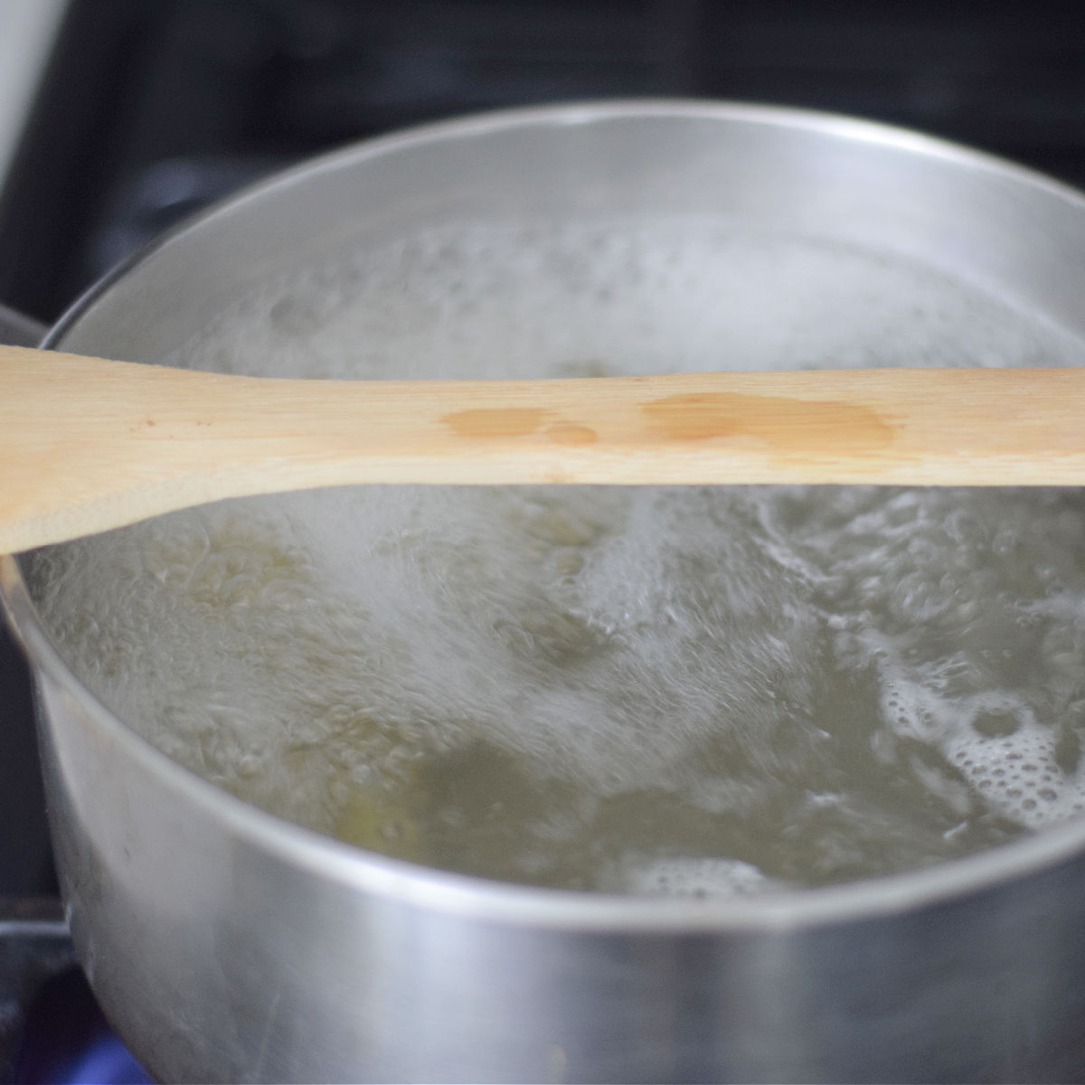 wooden spoon over boiling water