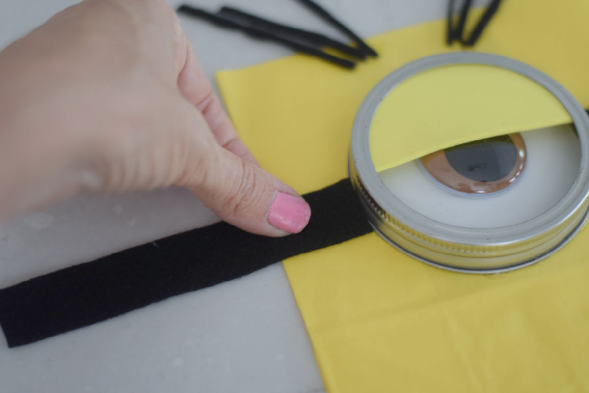 gluing goggle straps on Minion eyes 