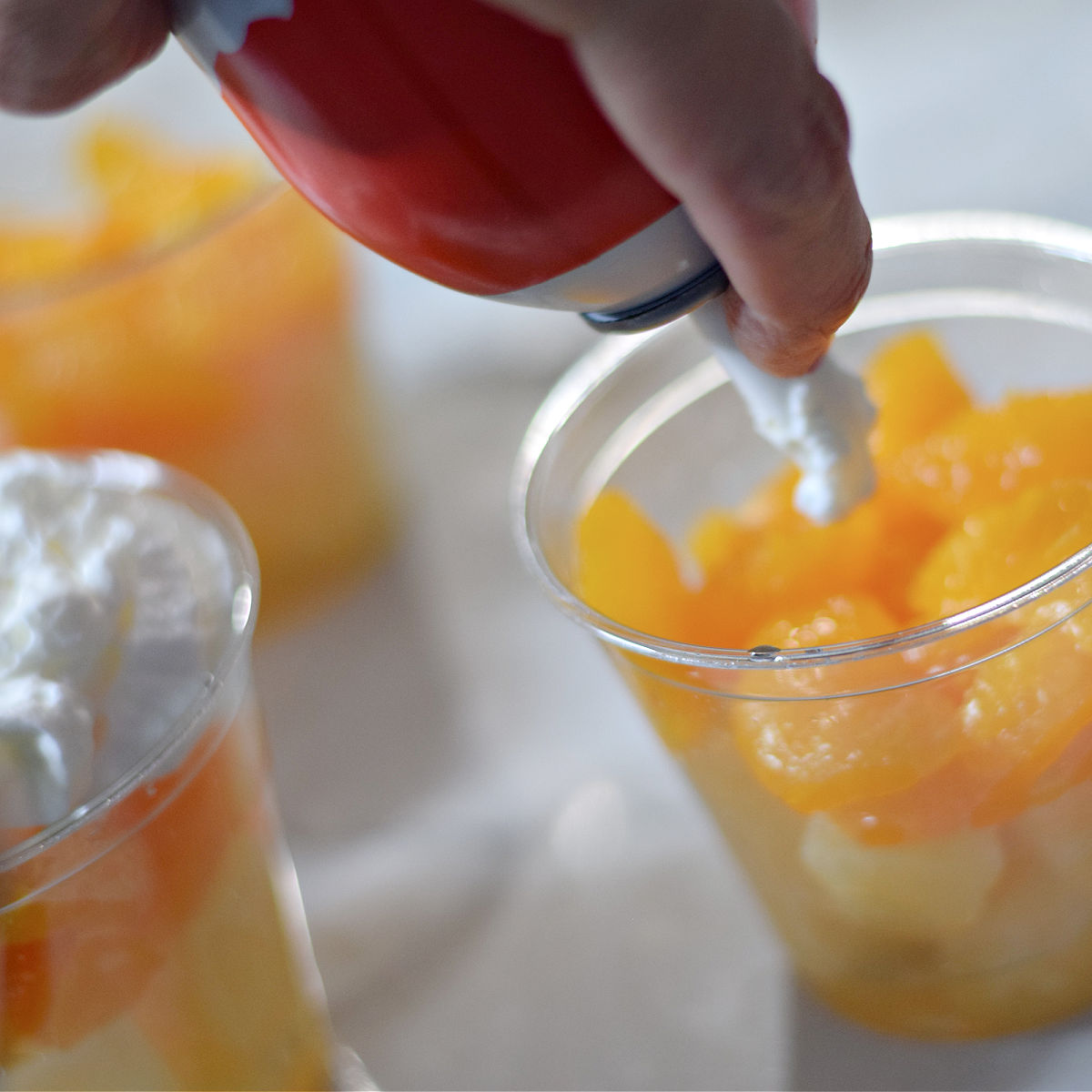 making Halloween fruit parfait treats 